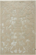 A rectangular area rug in a light beige or cream tone with a raised, abstract floral or leafy pattern in a slightly lighter off-white shade.