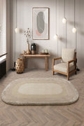 Living room with a round beige rug, wooden chair, and abstract art on the wall.