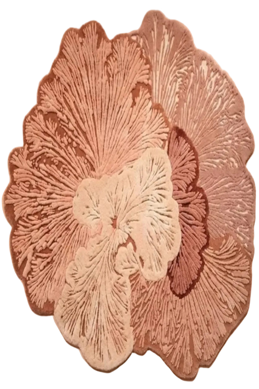 A decorative floral wall hanging or sculpture made of layered, textured flower-like petals in dusty pink, mauve, cream, and brown tones, photographed against a plain warm beige wall.