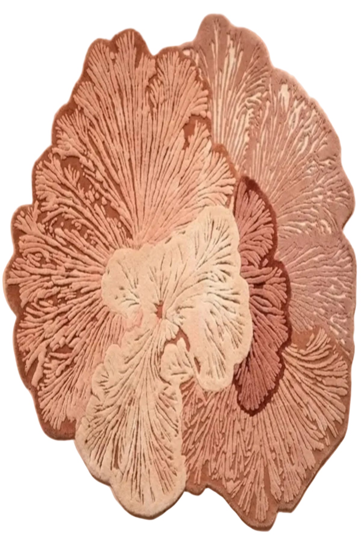 A decorative floral wall hanging or sculpture made of layered, textured flower-like petals in dusty pink, mauve, cream, and brown tones, photographed against a plain warm beige wall.