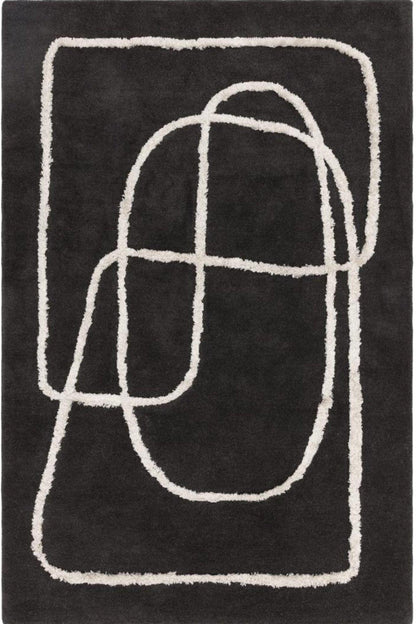 Black rug with white abstract patterns on a plain background