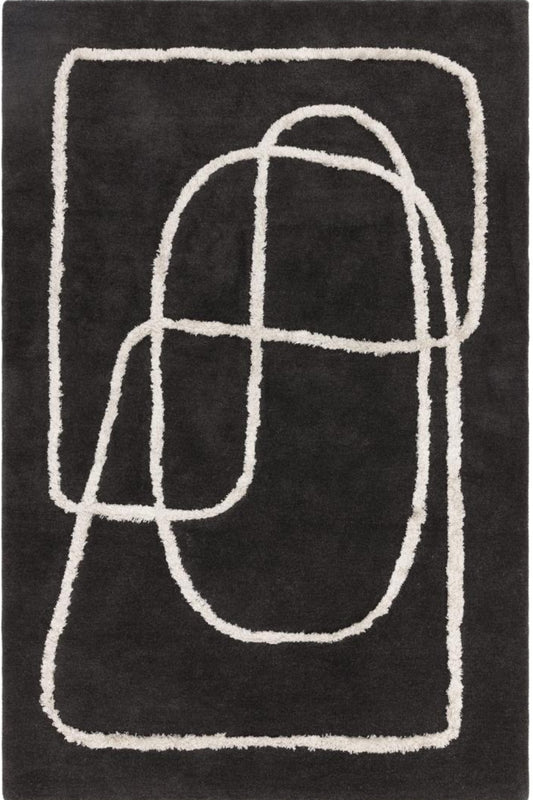 Black rug with white abstract patterns on a plain background