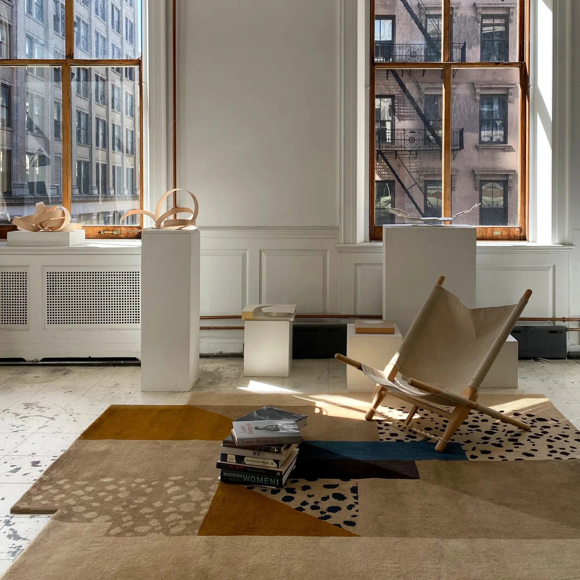 Modern interior with a chair, rug, and large windows. Nordic | kaleenvibe