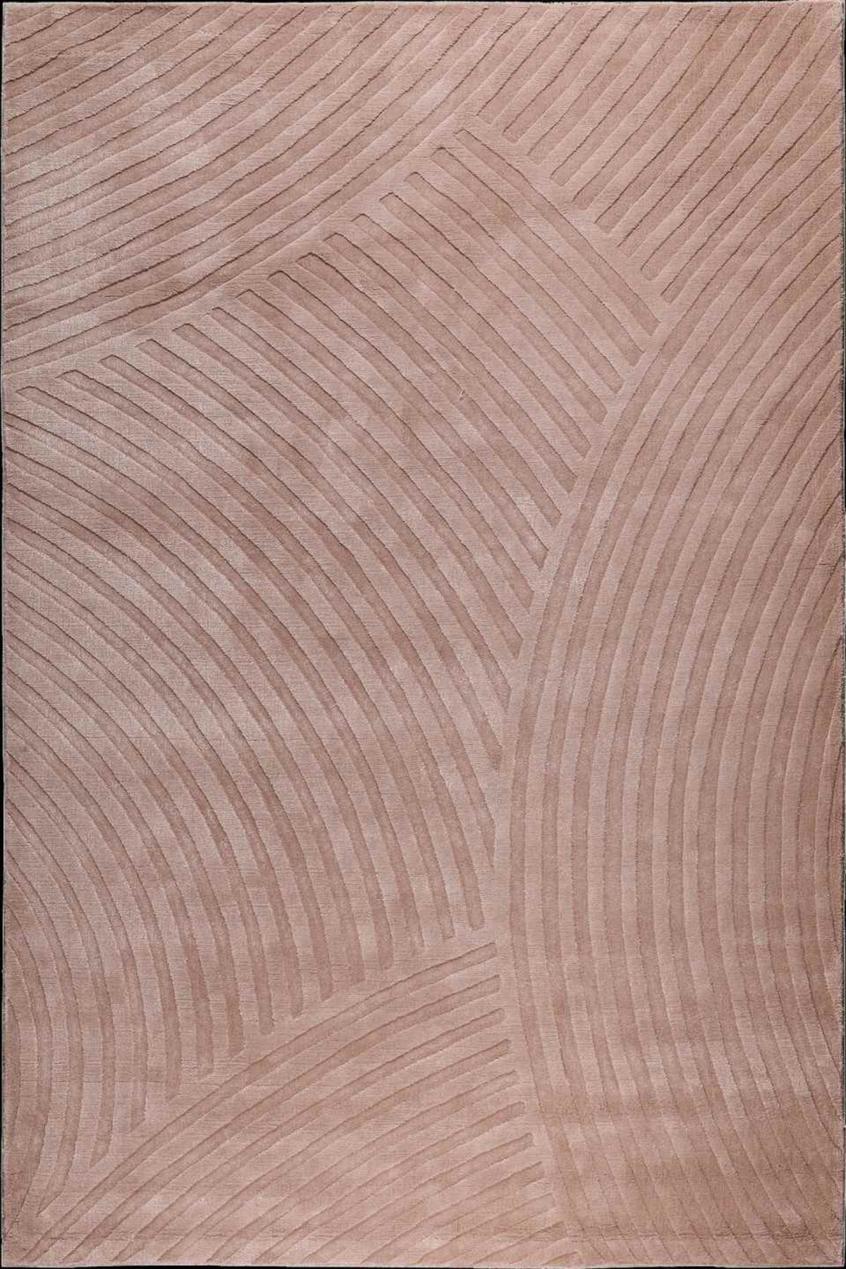 A close-up of a textured rug or fabric in a warm taupe-beige color, featuring a raised geometric pattern of curved lines.