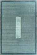 A rectangular area rug with a geometric pattern featuring concentric rectangular lines in shades of slate blue, teal, and navy, with a central vertical panel of a lighter blue-gray.