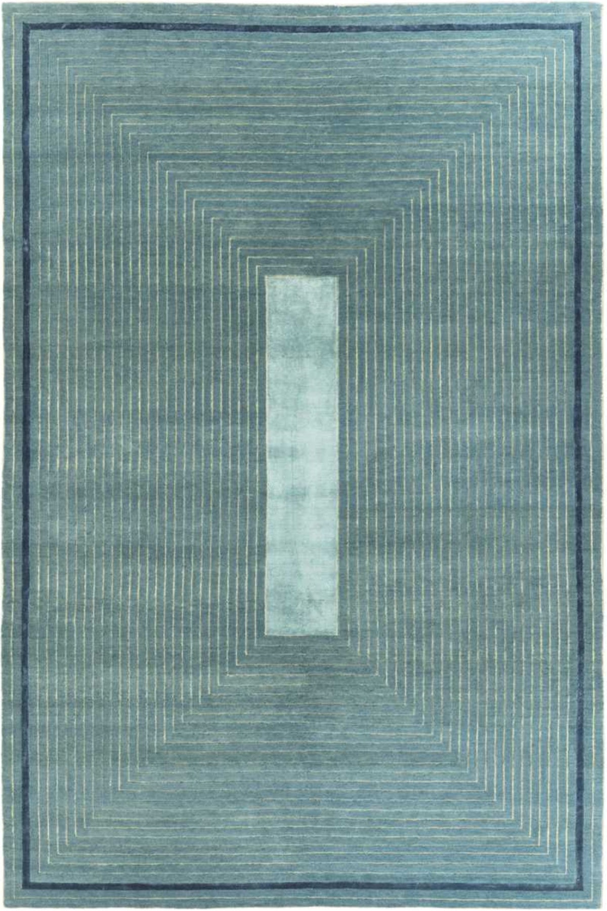 A rectangular area rug with a geometric pattern featuring concentric rectangular lines in shades of slate blue, teal, and navy, with a central vertical panel of a lighter blue-gray.
