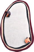 Oval-shaped mat with maroon border and two small orange objects on a white background