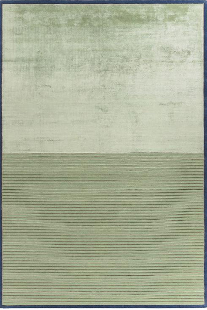 A rectangular area rug with a two-tone design, featuring a textured light sage green upper half and a ribbed olive green lower half, finished with a dark blue border.