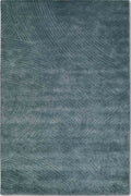 A rectangular area rug with a textured, abstract pattern in slate blue and gray tones, shown flat against a white background.