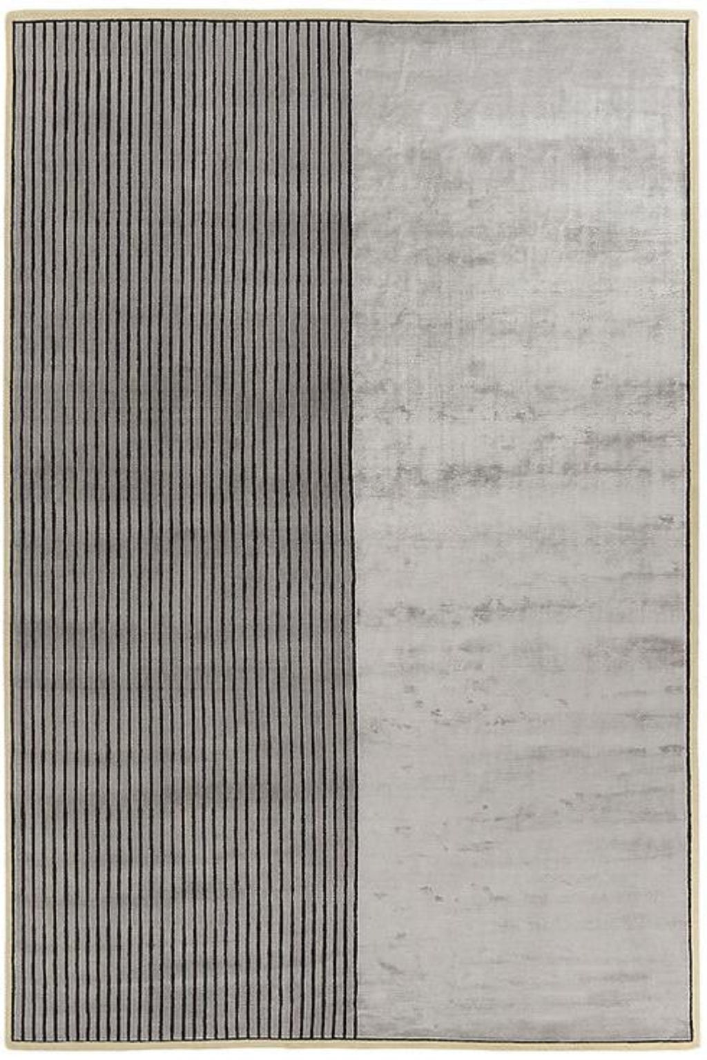 A rectangular area rug with a modern minimalist design, featuring a vertical split with a left panel of thin dark vertical stripes on a light gray background and a right panel of mottled light gray texture.